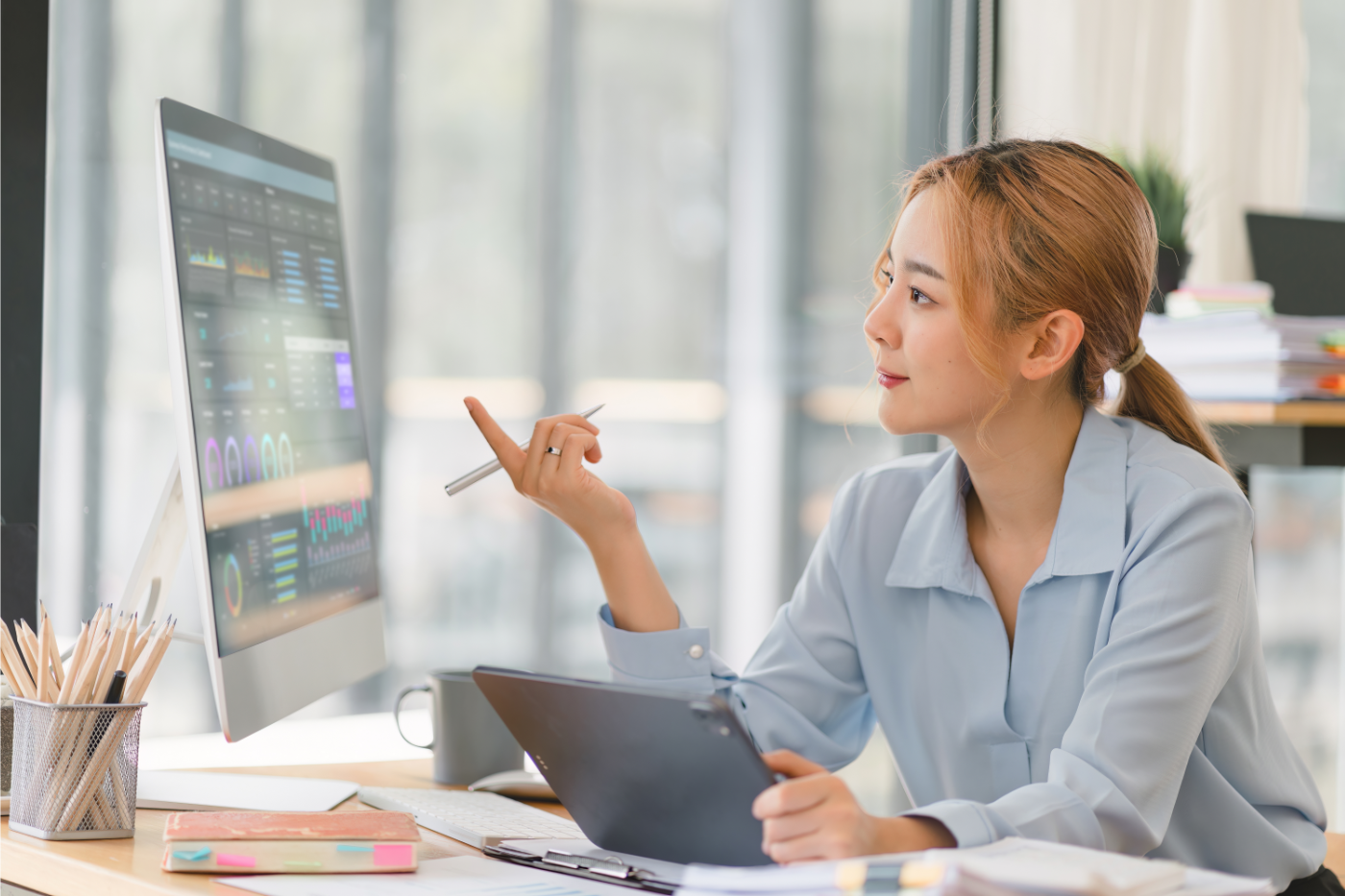 Financial Services Consultant Pointing at Graphs on Screen